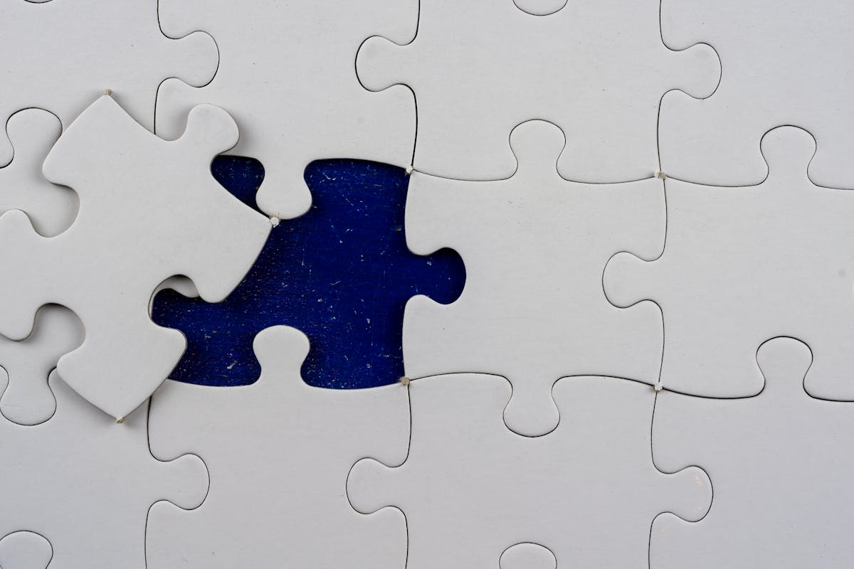 A nearly-complete white jigsaw puzzle with one piece sitting outside its slot, exposing the blue surface beneath — visual metaphor for one wrong byte breaking the whole serialized array (photo: Mike Van Schoonderwalt / Pexels)
