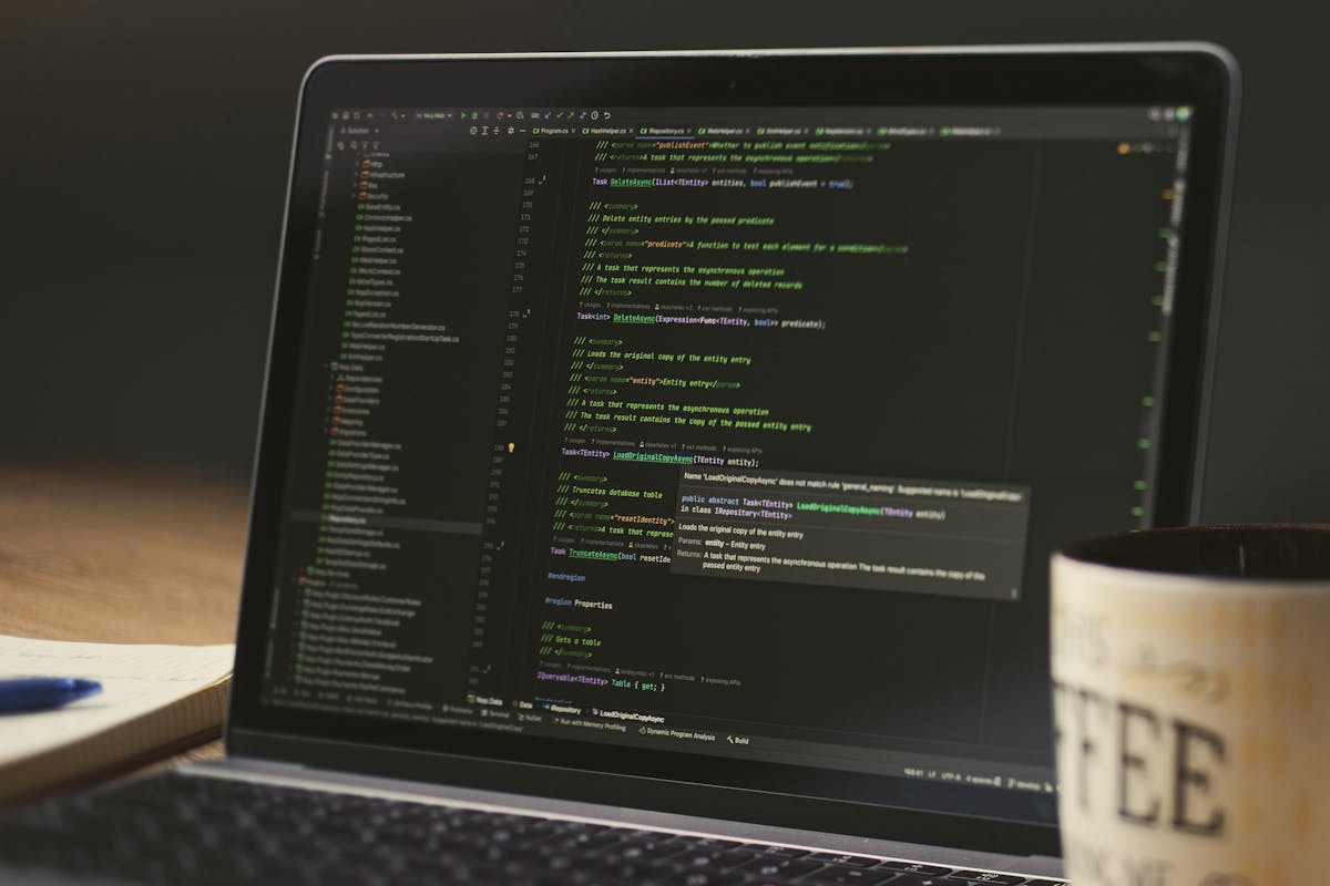 Laptop displaying a code editor with class hierarchy panel and method documentation tooltip — typical view when reading inherited legacy code (photo: DKomov / Pexels)