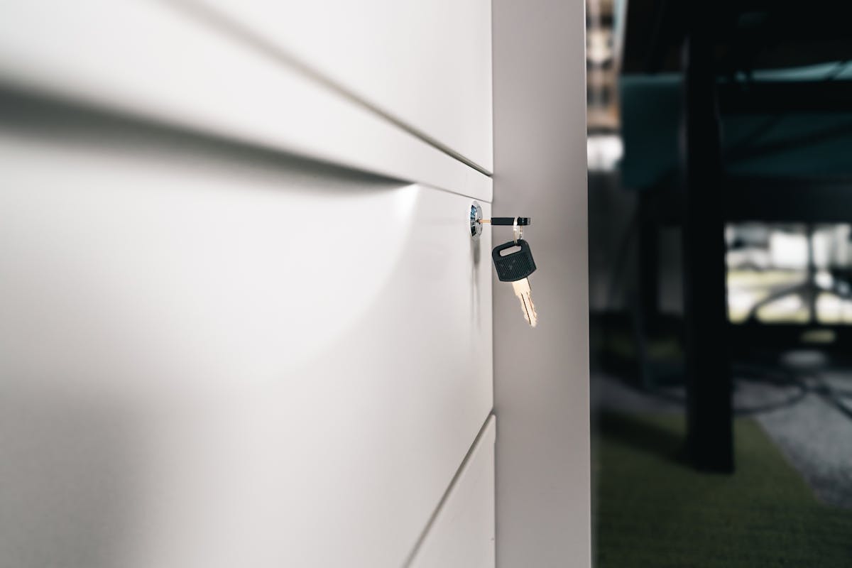 A single key resting in a locker door, symbolizing per-site database credentials with no shared master key (photo: Jakub Zerdzicki / Pexels)