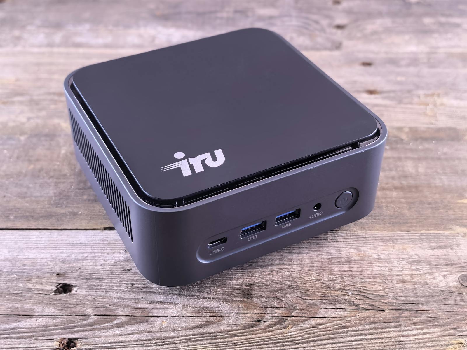 Black mini PC with USB ports on a wooden surface — photo by zeleboba on Pexels