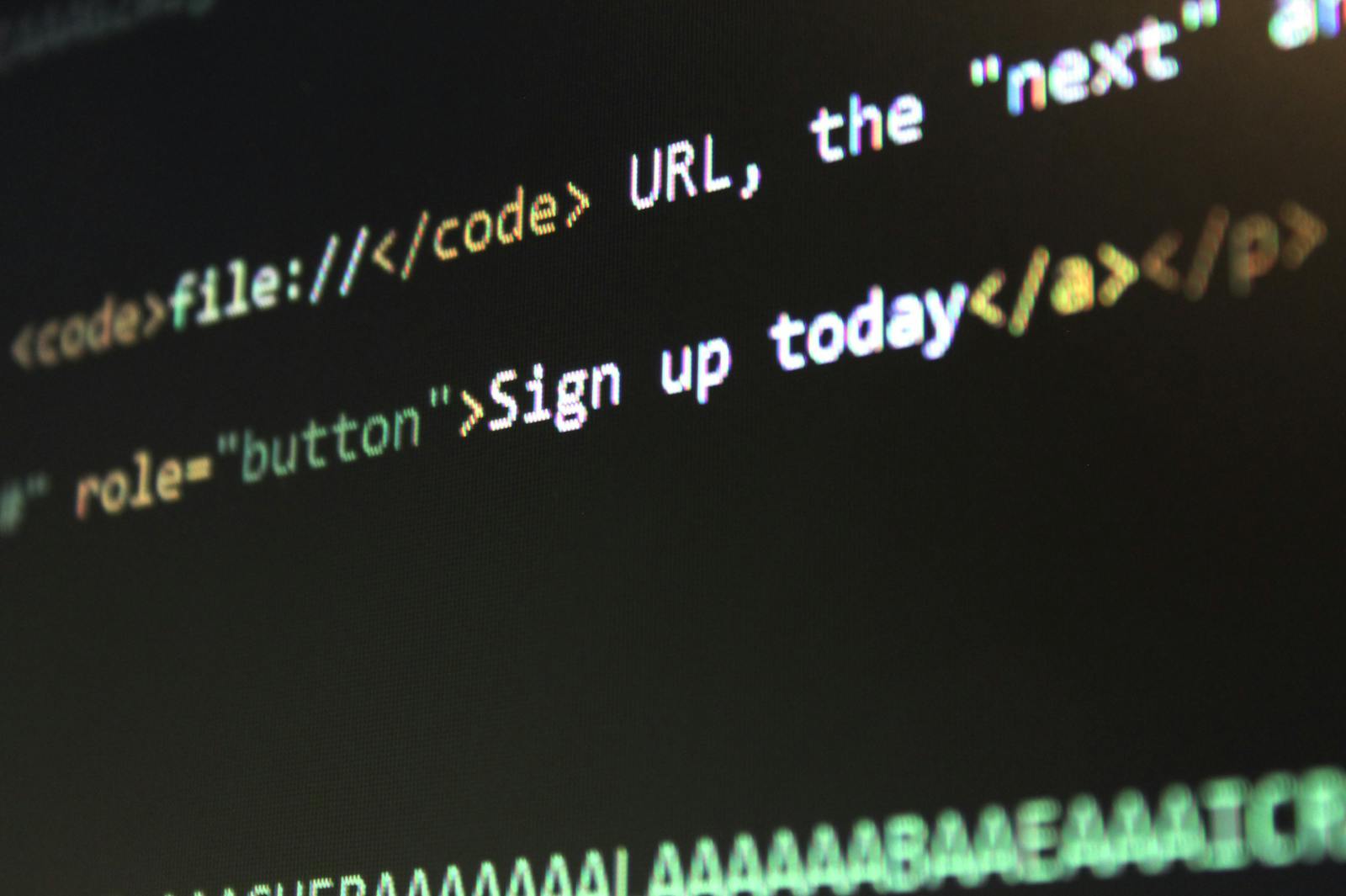 Close-up of HTML code on a dark monitor — photo by Pixabay on Pexels