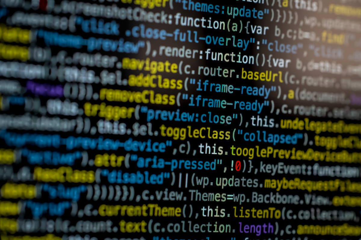 Close-up of WordPress JavaScript source code displaying themes:update functions and wp.updates handlers — typical view when auditing WordPress code (photo: Markus Spiske / Pexels)