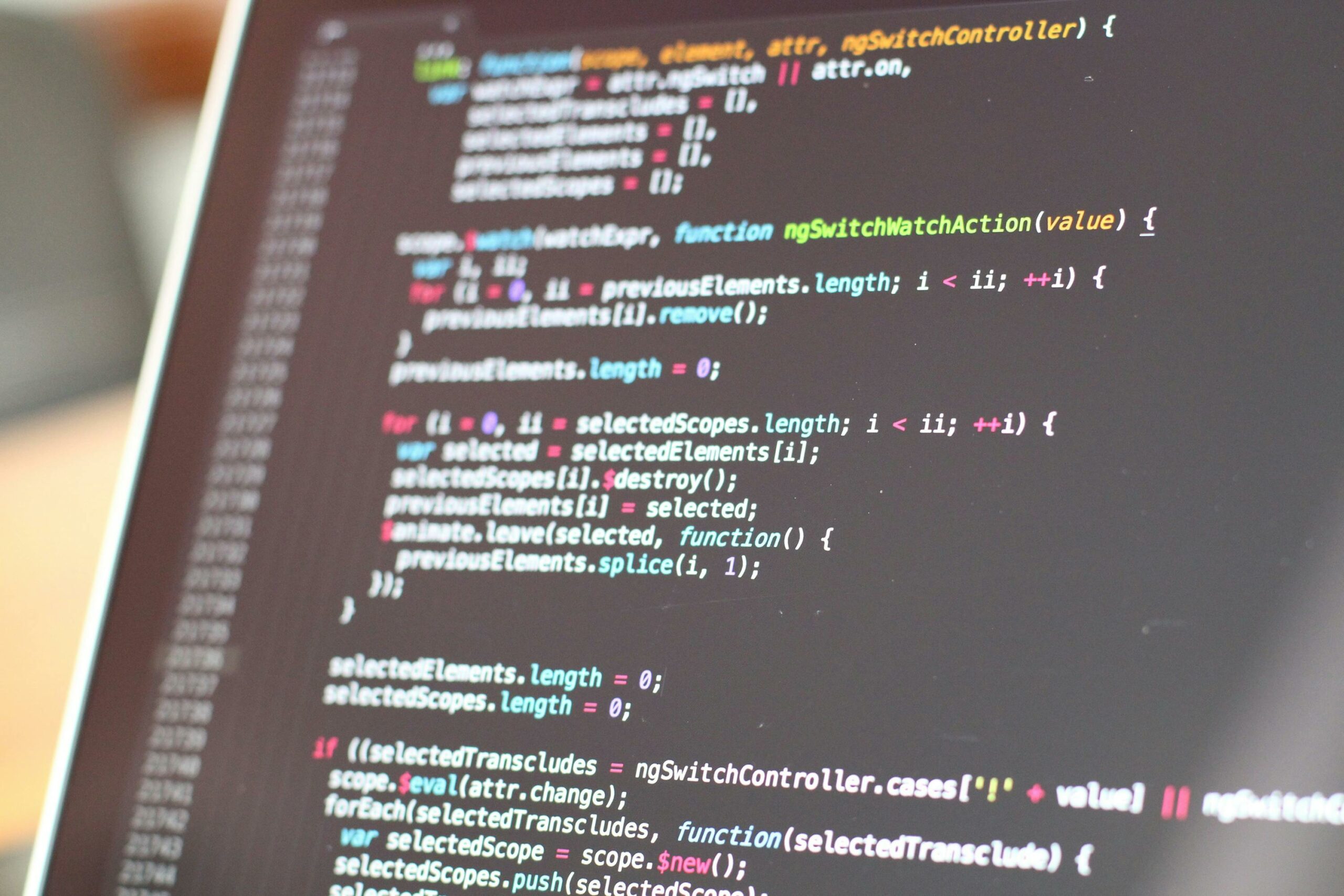 Close-up of source code on a dark monitor — photo by Pixabay on Pexels