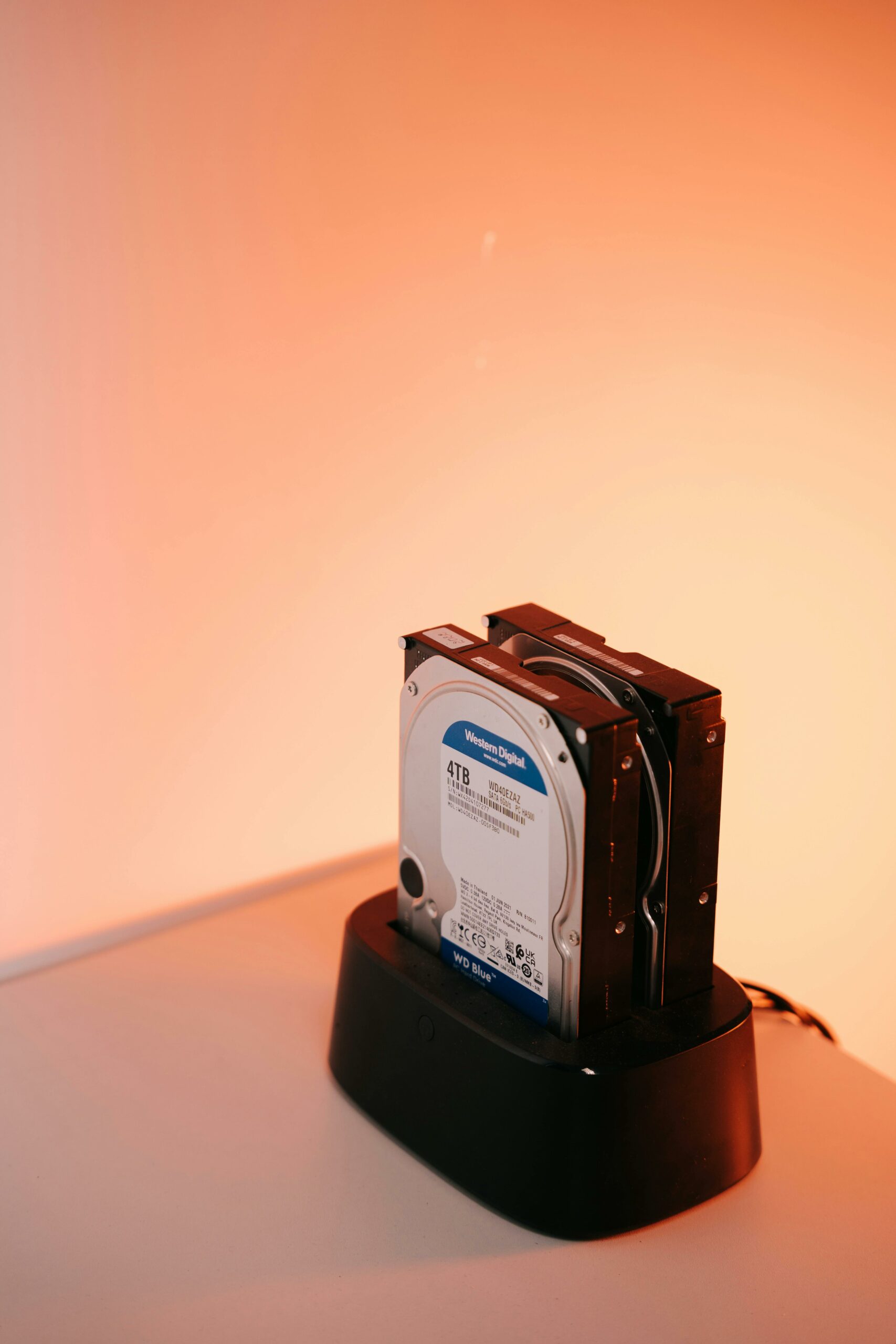 Western Digital 4TB hard drive seated in a desktop docking station — photo by Alphaen on Pexels
