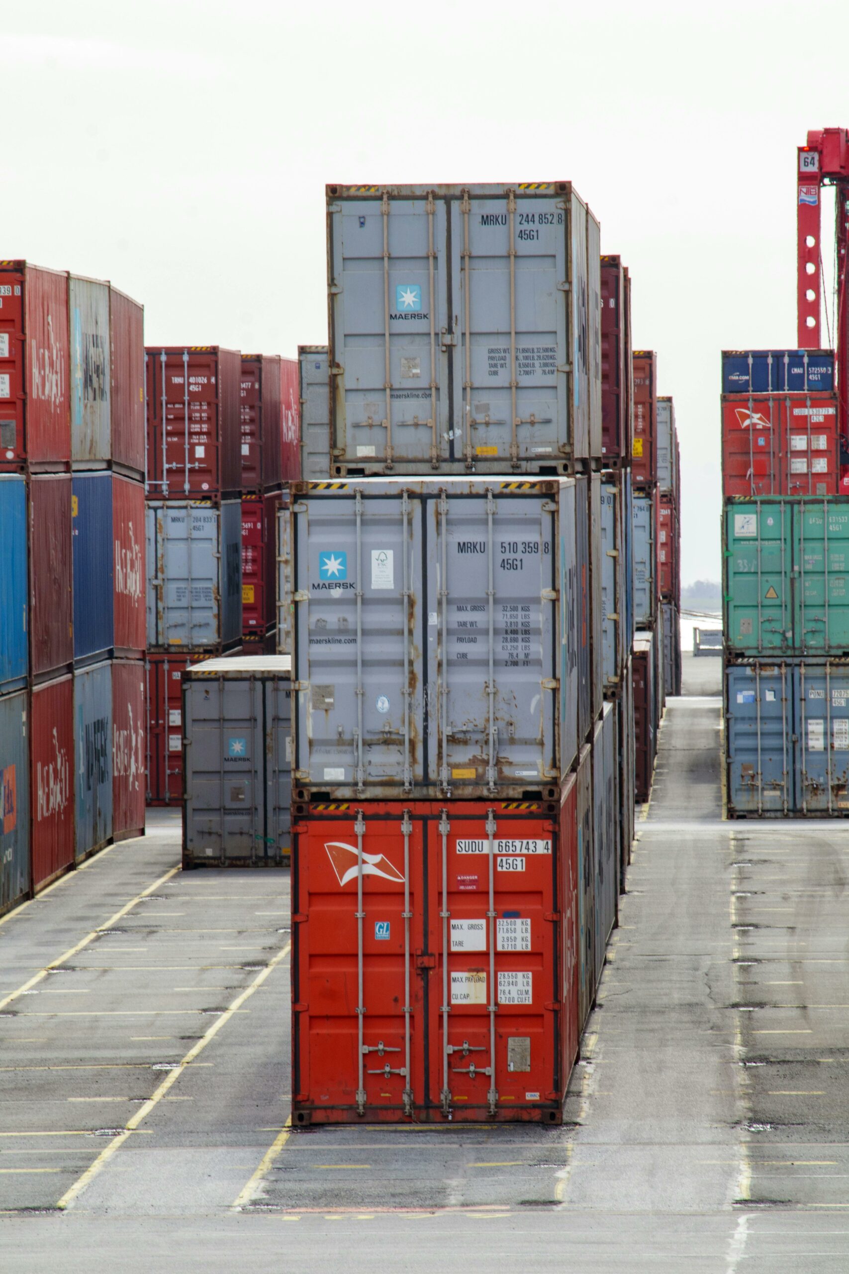 Stacked shipping containers in a port yard — photo by Felix Haumann on Pexels