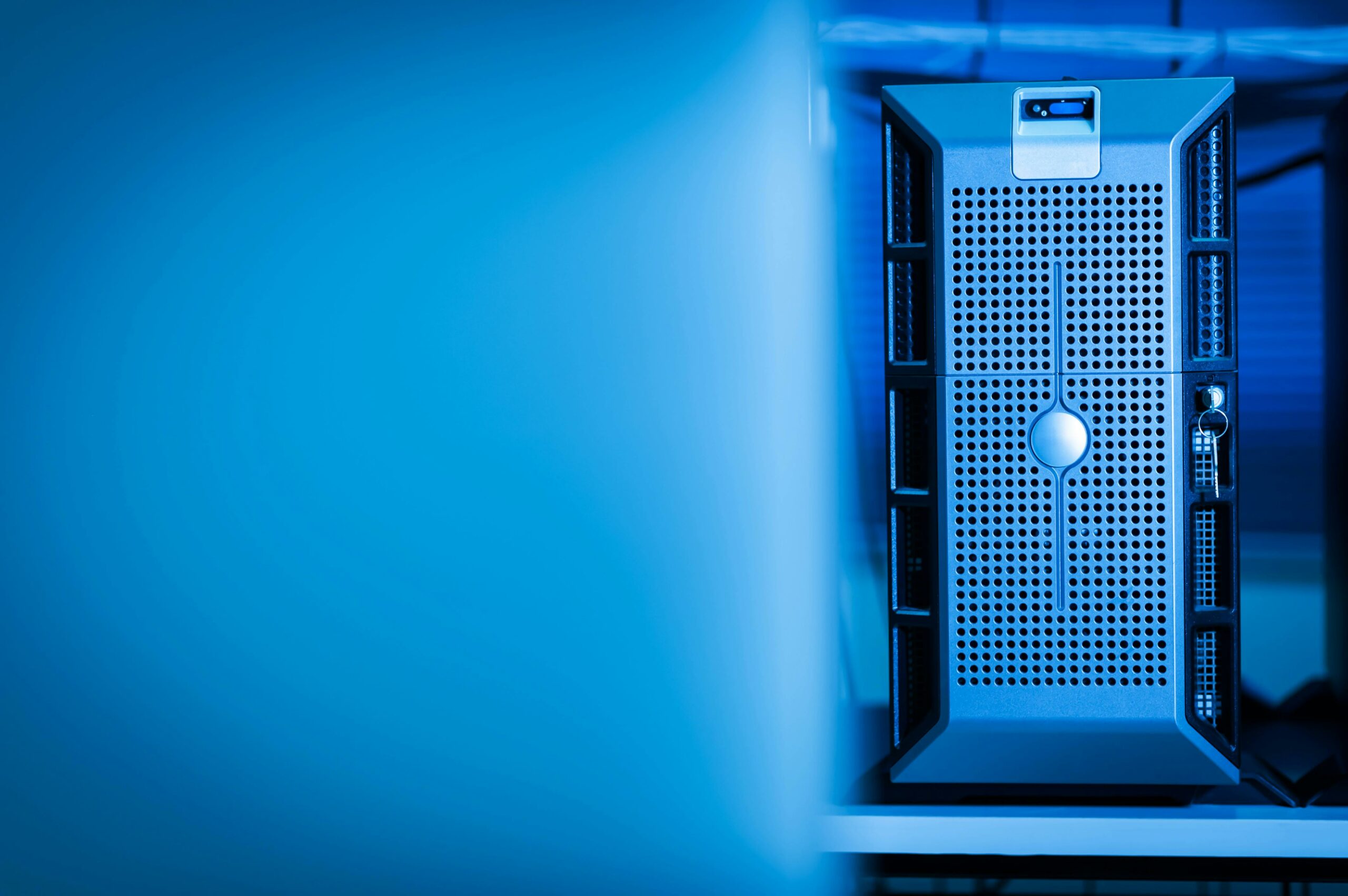 Server tower in a blue-lit data centre — photo by Cookiecutter on Pexels