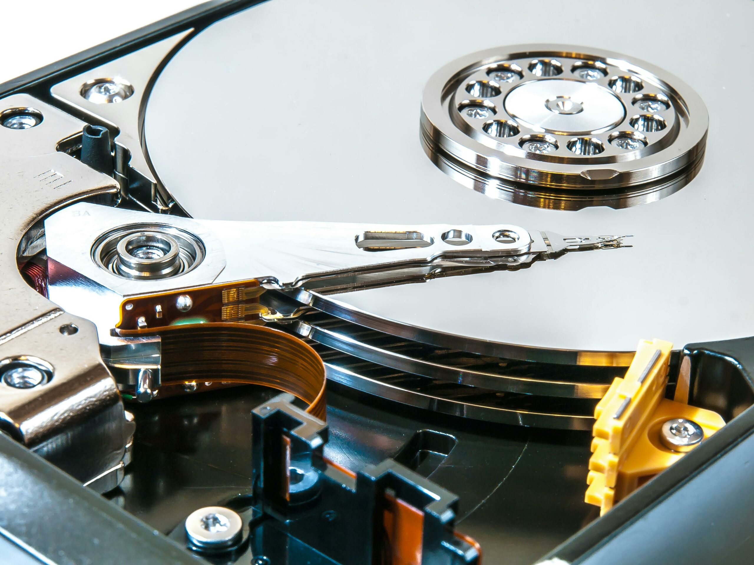Open hard drive showing platters and read-write head — photo by wwarby on Pexels